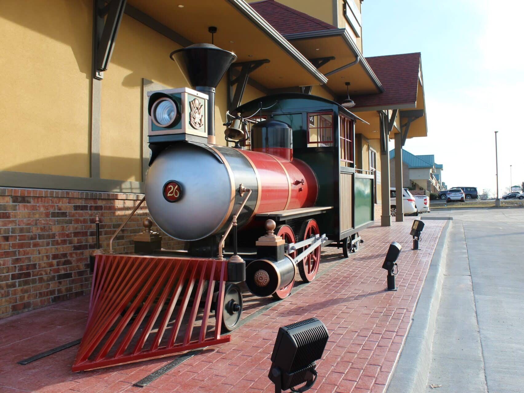 A prop train for Dental Depot in Blue Springs sits outside of the office on brick pavement.