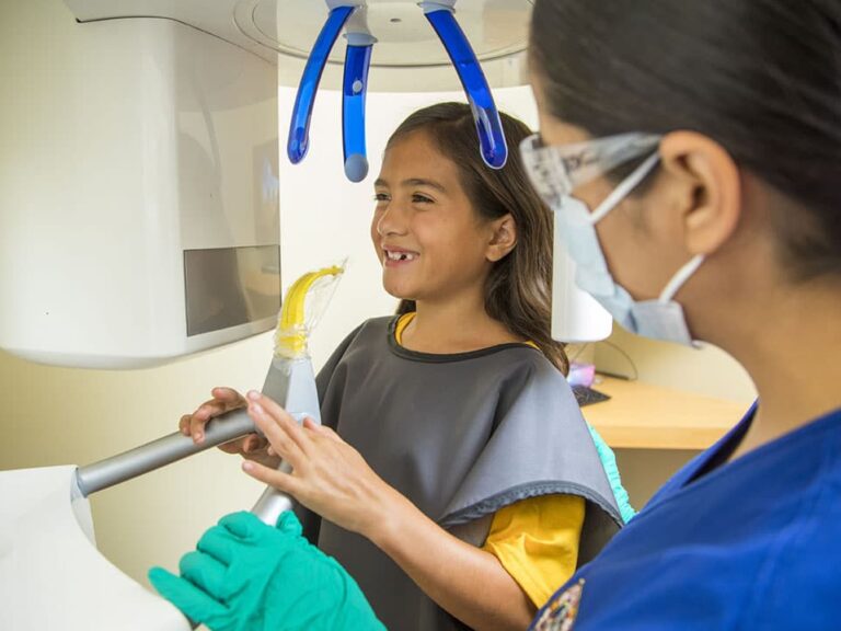 A girl gets ready for dental xrays at dental depot