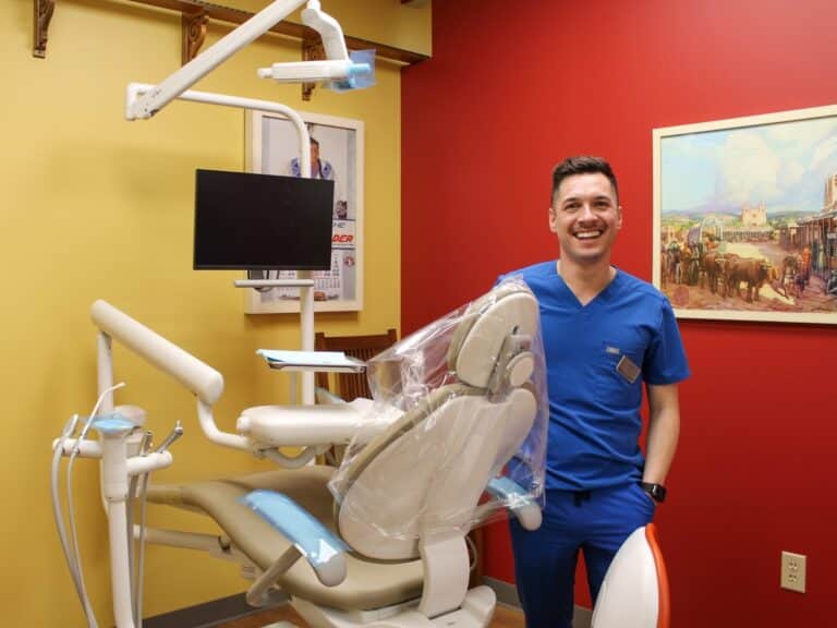 Smiling dentist in operatory